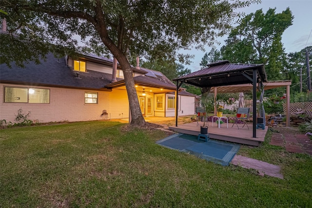 5942 Pebble Springs Dr, Houston, TX 77066 - rear view of property with a gazebo, a deck, a yard, brick siding, and a shingled roof