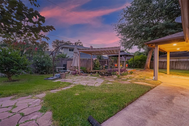 5942 Pebble Springs Dr, Houston, TX 77066 - yard at dusk with a patio area, a gazebo, and a fenced backyard