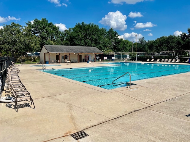 1403 Maygrove Dr, Sugar Land, TX 77498 - community pool with a patio area and view of scattered trees