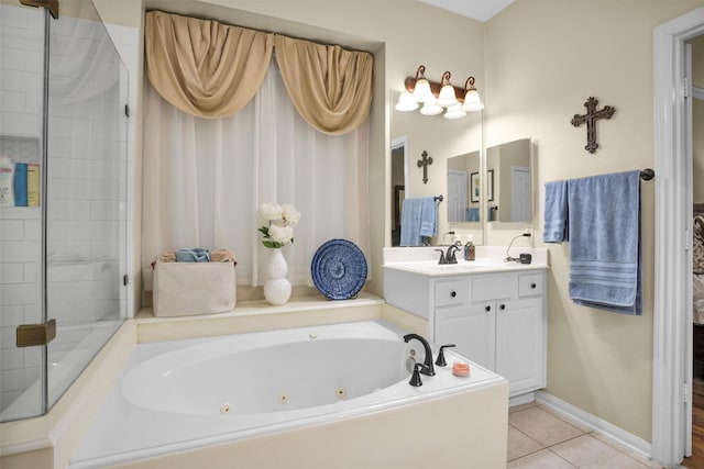 21006 Indigo Field Ln, Richmond, TX 77407 - full bath featuring a tub with jets, vanity, and tile patterned flooring