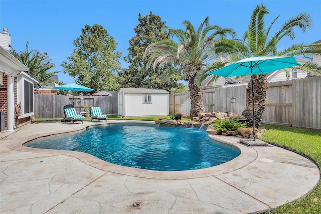 21006 Indigo Field Ln, Richmond, TX 77407 - view of swimming pool featuring a patio, a fenced backyard, and a storage shed