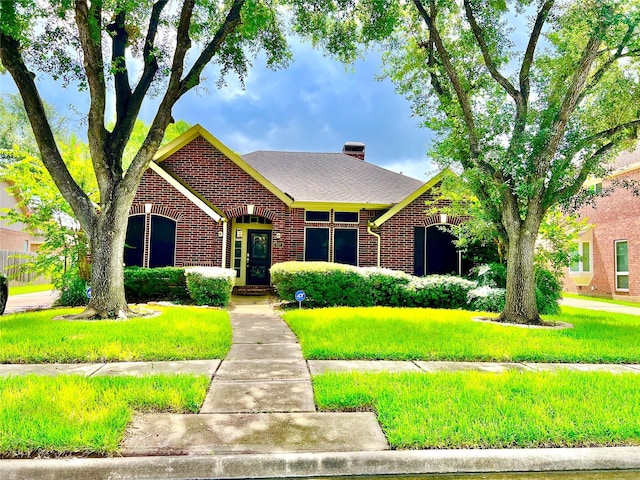 807 Epperson Way Ct, Sugar Land, TX 77479 - view of front of house with brick siding, a front yard, and a chimney