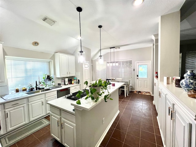 807 Epperson Way Ct, Sugar Land, TX 77479 - kitchen with stainless steel appliances, light countertops, white cabinetry, dark tile patterned flooring, and vaulted ceiling