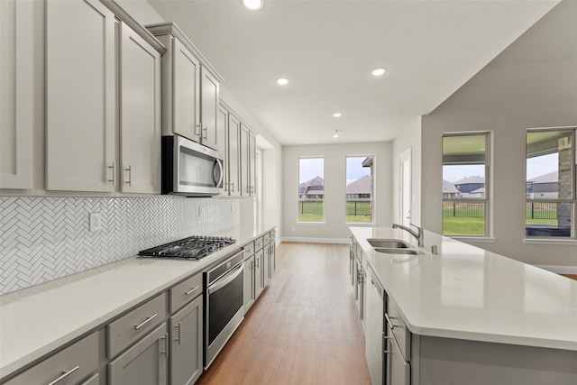 6322 Cambrai Wood Ln, Katy, TX 77493 - kitchen with appliances with stainless steel finishes, gray cabinetry, backsplash, and recessed lighting