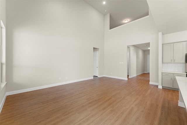 6322 Cambrai Wood Ln, Katy, TX 77493 - unfurnished living room with high vaulted ceiling and light wood finished floors