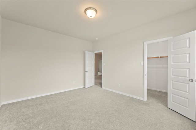 6322 Cambrai Wood Ln, Katy, TX 77493 - unfurnished bedroom featuring light carpet, a walk in closet, and a closet