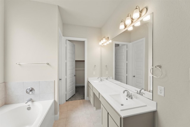 6322 Cambrai Wood Ln, Katy, TX 77493 - bathroom featuring double vanity, a bath, tile patterned flooring, and a spacious closet
