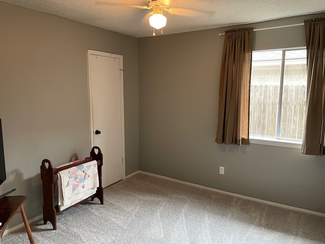 3202 The Highlands Dr, Sugar Land, TX 77478 - carpeted bedroom featuring a textured ceiling and a ceiling fan