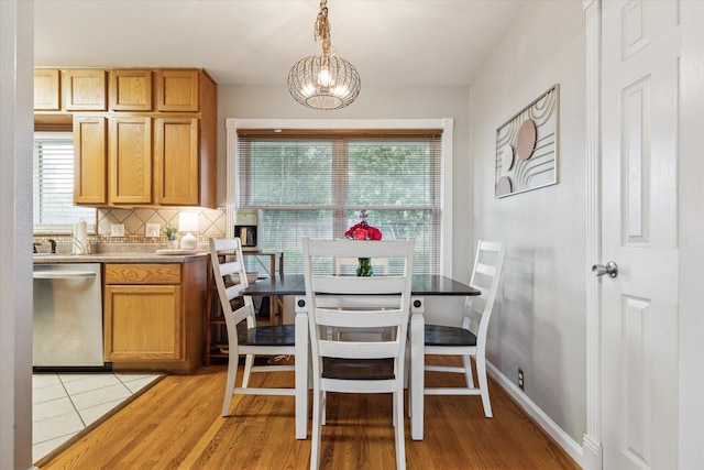 1130 W 30th St, Houston, TX 77018 - dining room featuring healthy amount of natural light, light wood-style floors, and a chandelier