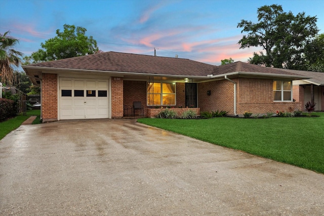 1130 W 30th St, Houston, TX 77018 - ranch-style house featuring concrete driveway, a garage, brick siding, and a lawn