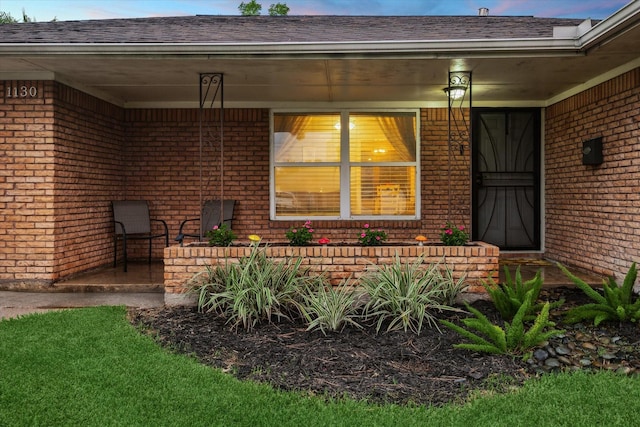 1130 W 30th St, Houston, TX 77018 - property entrance with brick siding, a shingled roof, and covered porch