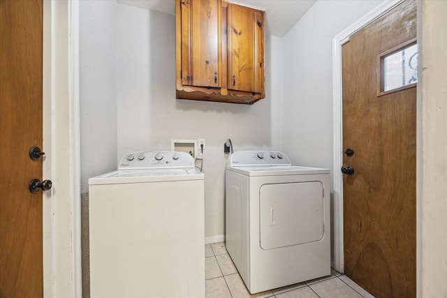 1130 W 30th St, Houston, TX 77018 - laundry area featuring cabinet space, washing machine and clothes dryer, and light tile patterned floors