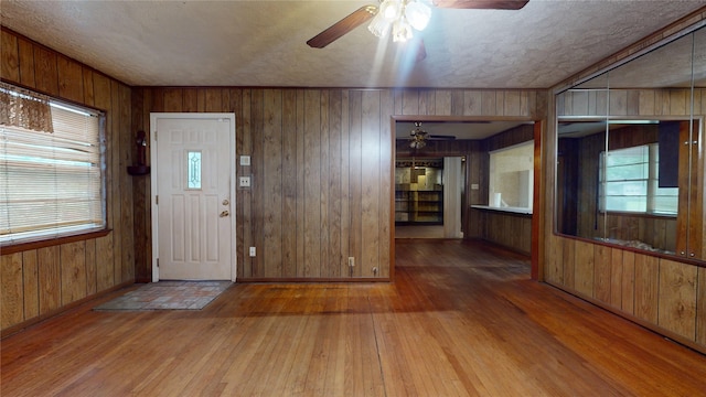 6619 Heron Dr, Houston, TX 77087 - entrance foyer featuring ceiling fan, wood-type flooring, and wooden walls