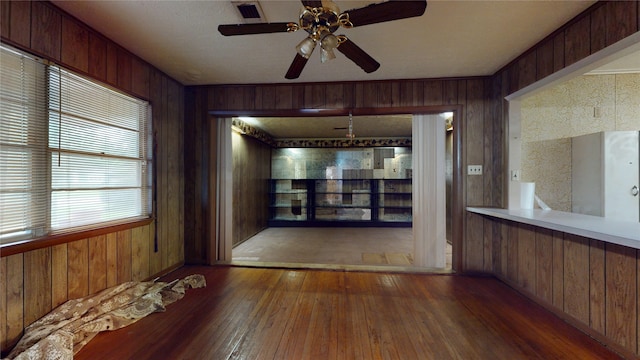 6619 Heron Dr, Houston, TX 77087 - spare room featuring wood walls, wood-type flooring, and ceiling fan