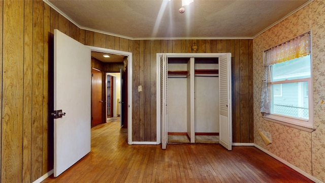 6619 Heron Dr, Houston, TX 77087 - unfurnished bedroom featuring hardwood / wood-style floors, crown molding, and a closet