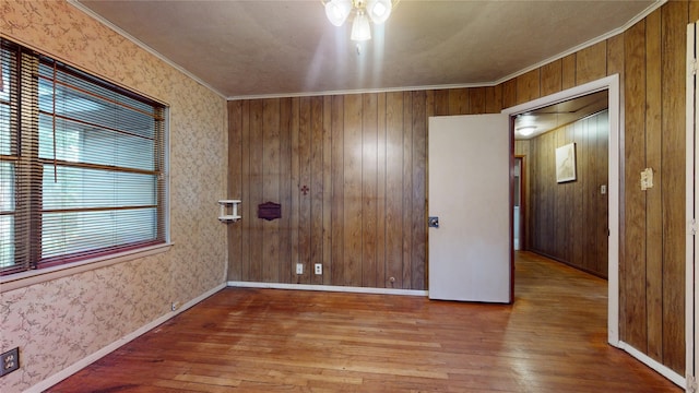 6619 Heron Dr, Houston, TX 77087 - unfurnished room with wood-type flooring, ornamental molding, and wooden walls