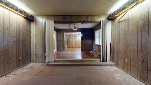6619 Heron Dr, Houston, TX 77087 - hallway featuring wood walls and a textured ceiling
