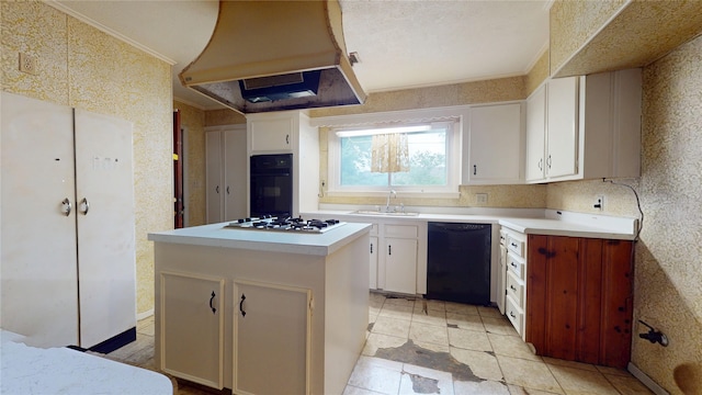 6619 Heron Dr, Houston, TX 77087 - kitchen with black appliances, range hood, light countertops, white cabinets, and a center island