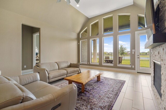 19019 Dappled Mare Cir, Tomball, TX 77377 - living area featuring a fireplace, tile patterned floors, ceiling fan, and high vaulted ceiling