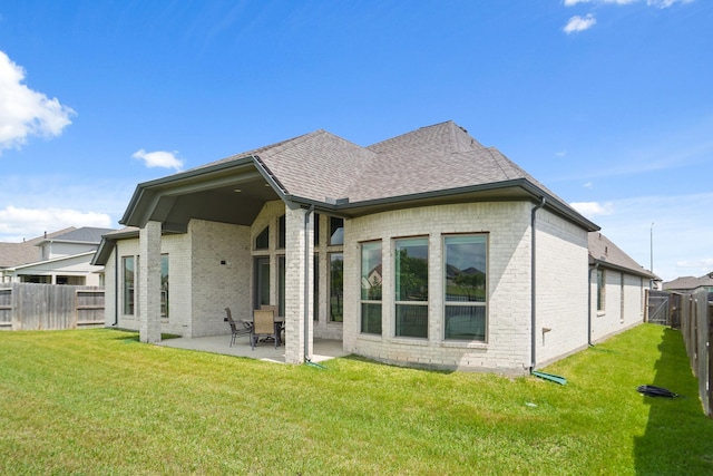 19019 Dappled Mare Cir, Tomball, TX 77377 - back of property featuring brick siding, a patio, a fenced backyard, and a shingled roof