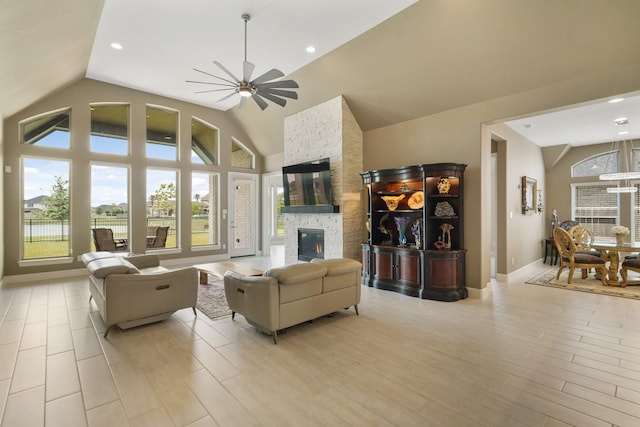 19019 Dappled Mare Cir, Tomball, TX 77377 - living area featuring lofted ceiling, a ceiling fan, healthy amount of natural light, a stone fireplace, and recessed lighting