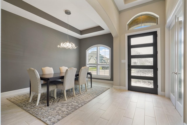19019 Dappled Mare Cir, Tomball, TX 77377 - entryway featuring a raised ceiling, a chandelier, and light wood-style floors