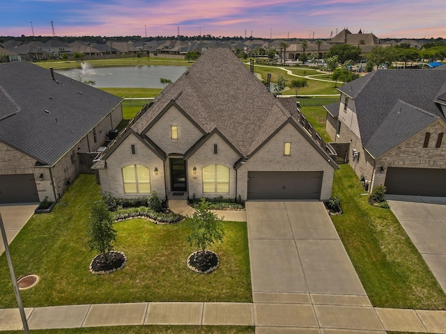 19019 Dappled Mare Cir, Tomball, TX 77377 - french provincial home featuring a residential view, brick siding, and driveway