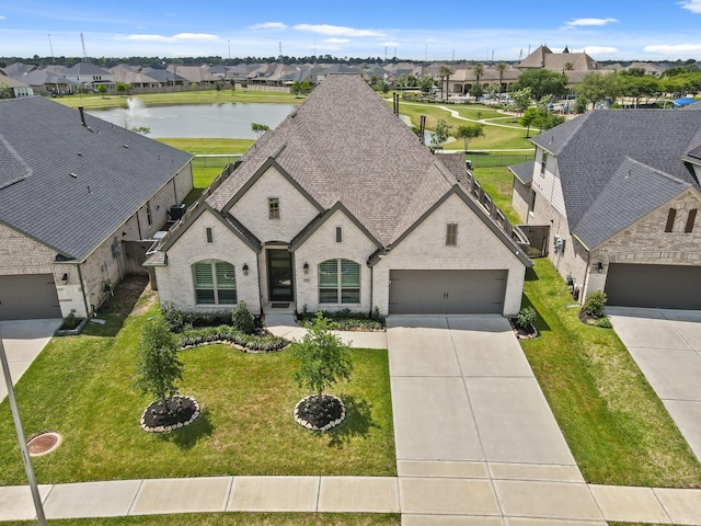 19019 Dappled Mare Cir, Tomball, TX 77377 - french country home featuring a residential view, brick siding, driveway, and a shingled roof