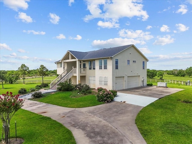 2250 Broadway St, San Leon, TX 77539 - view of home's exterior featuring stairway, an attached garage, driveway, and a shingled roof