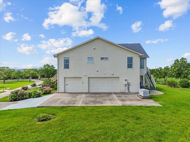 2250 Broadway St, San Leon, TX 77539 - view of side of property featuring a garage, driveway, stairs, and a lawn