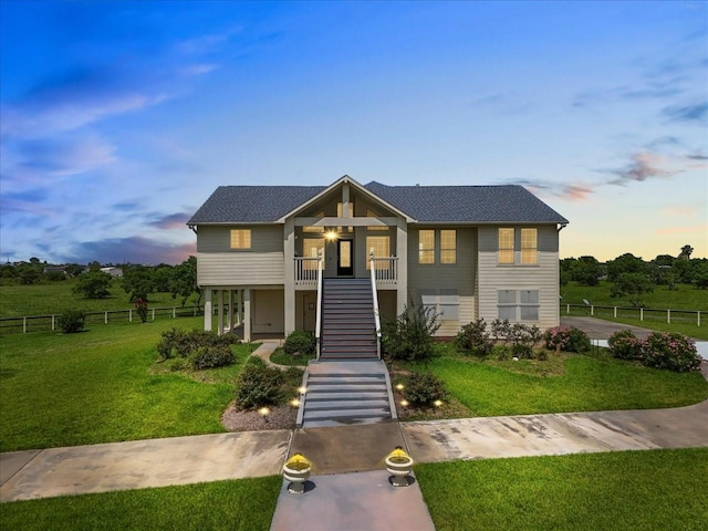 2250 Broadway St, San Leon, TX 77539 - view of front of home featuring stairway, covered porch, and a shingled roof