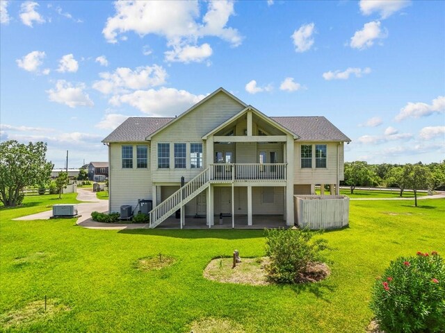 2250 Broadway St, San Leon, TX 77539 - back of house with a lawn, a patio area, stairs, and a shingled roof