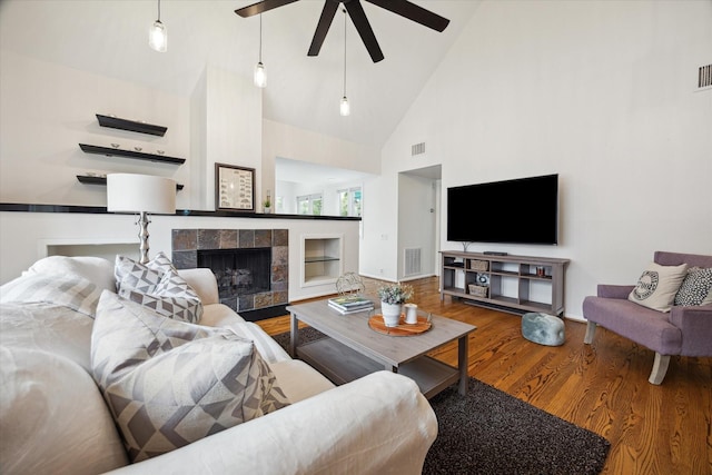 1395 Arlington St Unit 1395, Houston, TX 77008 - living room featuring high vaulted ceiling, wood finished floors, a ceiling fan, and a tiled fireplace