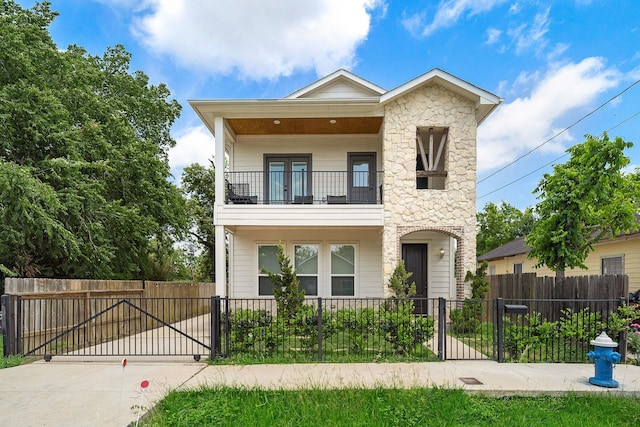 4209 Gunter St, Houston, TX 77020 - view of front of home featuring a balcony, a gate, stone siding, and a fenced front yard
