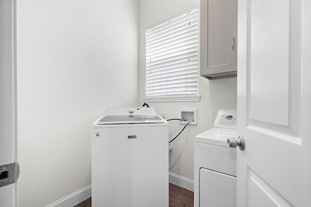 4209 Gunter St, Houston, TX 77020 - washroom with washer and dryer, dark wood finished floors, and cabinet space