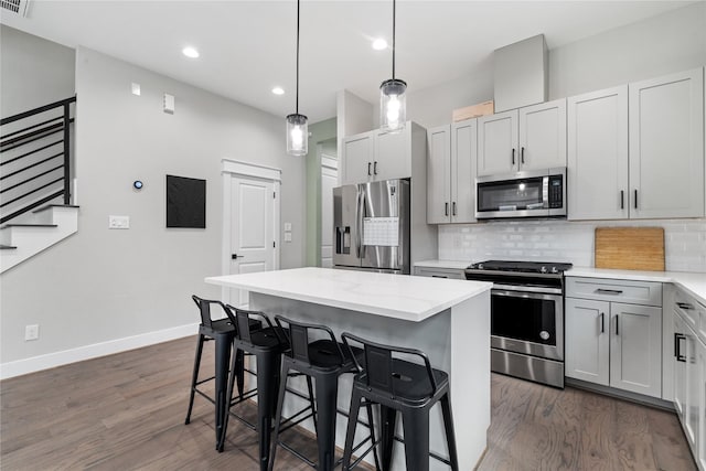 4510 Vernon St, Houston, TX 77020 - kitchen with appliances with stainless steel finishes, dark wood finished floors, a center island, tasteful backsplash, and recessed lighting