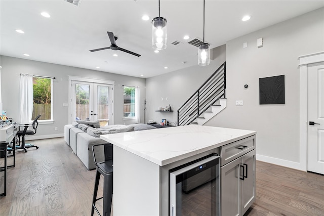 4510 Vernon St, Houston, TX 77020 - kitchen featuring wine cooler, wood finished floors, a ceiling fan, open floor plan, and recessed lighting