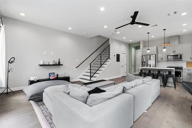 4510 Vernon St, Houston, TX 77020 - living area featuring ceiling fan, recessed lighting, stairway, and wood finished floors