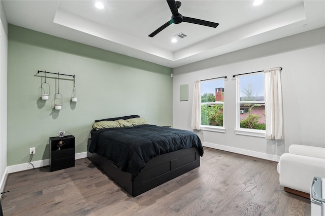 4510 Vernon St, Houston, TX 77020 - bedroom with a tray ceiling, recessed lighting, wood finished floors, and ceiling fan