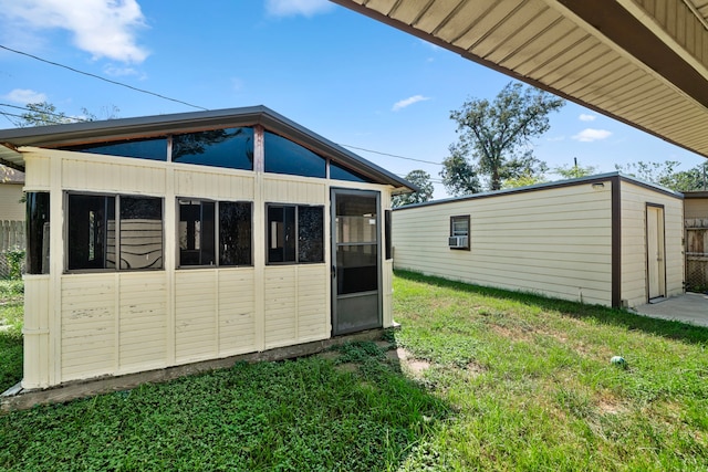 56 Wellford St, Houston, TX 77022 - view of home's exterior with an outdoor structure and a lawn
