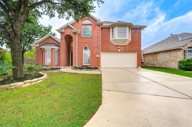 22934 Cove Timbers Ct, Tomball, TX 77375 - traditional-style home featuring a garage, concrete driveway, brick siding, and a front yard