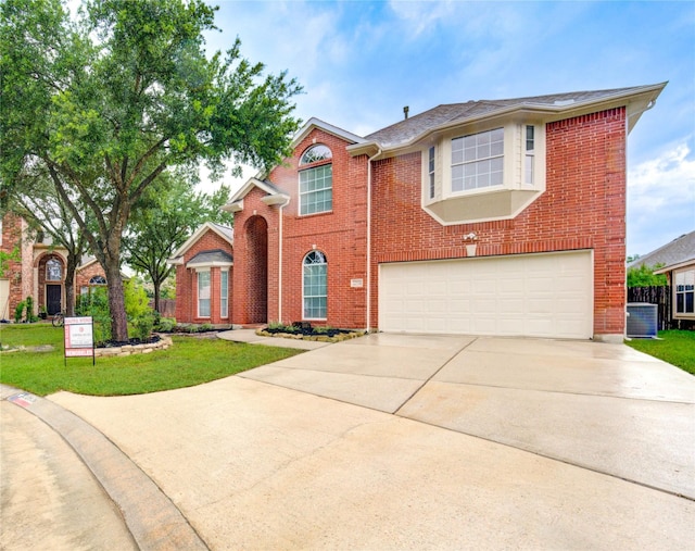 22934 Cove Timbers Ct, Tomball, TX 77375 - traditional-style home featuring a garage, driveway, brick siding, and a front lawn