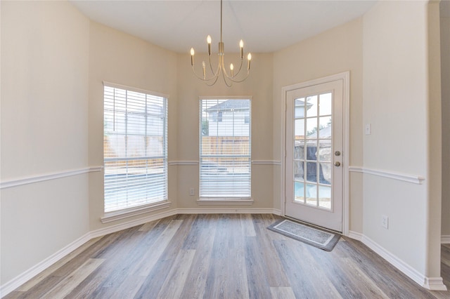 22934 Cove Timbers Ct, Tomball, TX 77375 - unfurnished dining area featuring a chandelier and wood finished floors