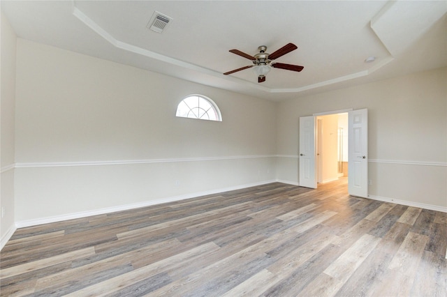 22934 Cove Timbers Ct, Tomball, TX 77375 - unfurnished room featuring a tray ceiling, ceiling fan, and wood finished floors
