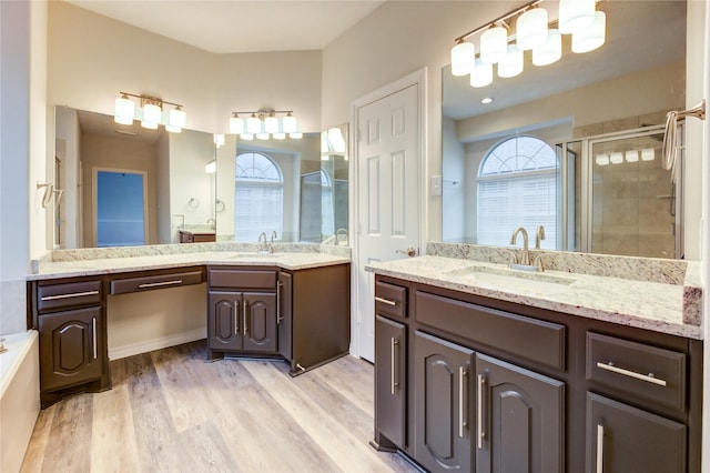 22934 Cove Timbers Ct, Tomball, TX 77375 - full bathroom with a shower stall, two vanities, wood finished floors, and a tub