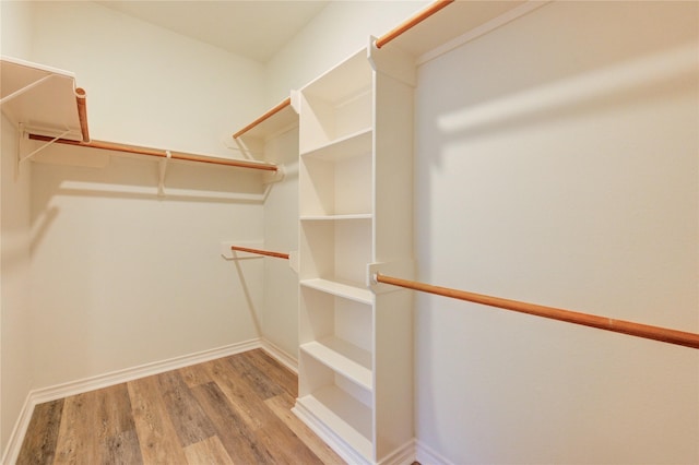 22934 Cove Timbers Ct, Tomball, TX 77375 - walk in closet featuring wood finished floors