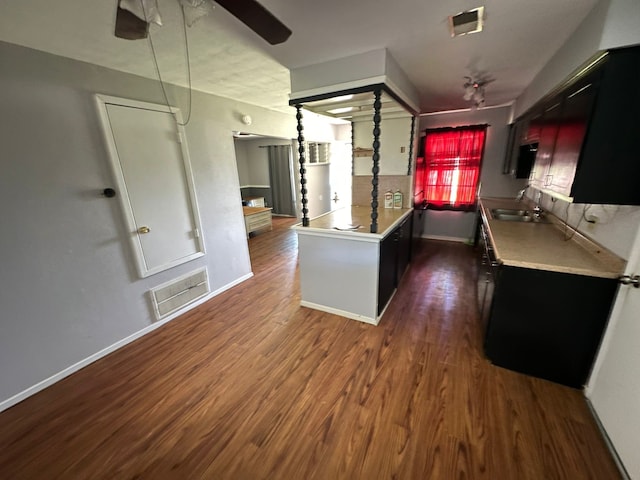 717 Circle Way, Alvin, TX 77511 - kitchen with ceiling fan, dark wood-type flooring, light countertops, and dark cabinetry