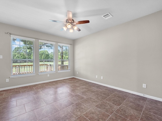 16020 Fountainview Dr Unit 21, Montgomery, TX 77356 - unfurnished room with ceiling fan and dark tile patterned flooring