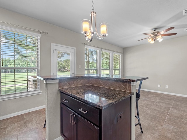 16020 Fountainview Dr Unit 21, Montgomery, TX 77356 - kitchen with a breakfast bar area, a chandelier, ceiling fan, decorative light fixtures, and a center island