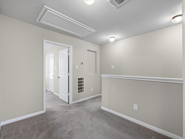 16020 Fountainview Dr Unit 21, Montgomery, TX 77356 - carpeted spare room featuring attic access and a textured ceiling
